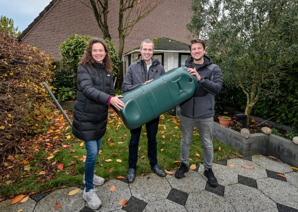 Familie Grosheide en wethouder Sjoerd Geissler met de prijs van de winactie: een regenton.